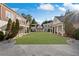 Large backyard with green grass, stone patio, blue sky, and well-maintained landscaping at , Roswell, GA 30075