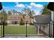 Expansive backyard with lush lawn, mature trees, and an iron fence, providing a private outdoor oasis at , Roswell, GA 30075