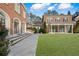 Large brick home with a manicured lawn at , Roswell, GA 30075