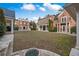 Large, landscaped backyard featuring an expansive lawn and sophisticated brick architecture at , Roswell, GA 30075