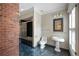 Bathroom featuring a glass shower, pedestal sink, and brick accent wall at , Roswell, GA 30075