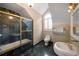 Bathroom featuring marble shower, single sink, and toilet with window at , Roswell, GA 30075