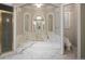 Elegant bathroom features a marble-surround tub, shower with gold trim, and decorative architectural details at , Roswell, GA 30075