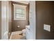 Cozy powder room features granite counters and custom cabinets, providing functional elegance at , Roswell, GA 30075
