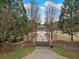 Gated entrance to the home with a brick wall and a long driveway at , Roswell, GA 30075