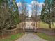 Gated driveway entrance with a brick wall and mature trees at , Roswell, GA 30075