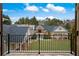 View of the rear of the house, showing the porch and landscaped yard with a black metal fence at , Roswell, GA 30075