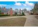 Expansive brick home features a circular driveway and meticulously maintained landscaping at , Roswell, GA 30075