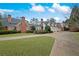 Expansive brick home features a circular driveway and meticulously maintained landscaping at , Roswell, GA 30075