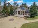 View of the brick home with white columns and a spacious driveway at , Roswell, GA 30075
