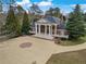 Grand home featuring prominent columns, a circular driveway, and manicured landscaping at , Roswell, GA 30075