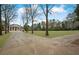 Grand two-story home featuring a long driveway and well-manicured lawn at , Roswell, GA 30075
