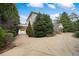 Beautiful two-story home with brick and siding exterior, circular driveway, and mature trees at , Roswell, GA 30075