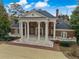 Magnificent two-story brick home with grand columns, manicured landscaping, and a circular driveway at , Roswell, GA 30075