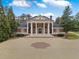 Grand exterior of the home features a large circular driveway and a portico with white columns at , Roswell, GA 30075
