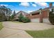 Beautiful two-story brick home with a three-car garage, a large circular driveway, and a covered porch at , Roswell, GA 30075