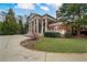 Stately brick home featuring a manicured lawn and an imposing facade with large columns at , Roswell, GA 30075