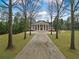 Spacious front yard with a long driveway leading up to the grand home at , Roswell, GA 30075