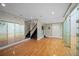 Spacious game room with hardwood floors, mirrored racquetball court, and staircase to another level at , Roswell, GA 30075