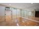 Hardwood floor game room with mirrored racquetball court, basketball hoop, and stairway at , Roswell, GA 30075