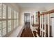 Hallway featuring hardwood floors, staircase, and bright light from shuttered windows at , Roswell, GA 30075