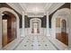 Elegant hallway with marble floors, arched doorways, and decorative columns at , Roswell, GA 30075