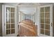 Elegant hallway showcasing hardwood floors and decorative columns, leading to various rooms at , Roswell, GA 30075
