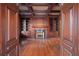 Well-appointed home office featuring a fireplace, built-in shelving and hardwood floors at , Roswell, GA 30075