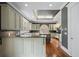 Well-designed kitchen with gray cabinets, granite countertops, stainless steel appliances, and hardwood floors at , Roswell, GA 30075