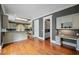 Bright eat-in kitchen with gray cabinetry, granite counters, hardwood floors, and stainless steel appliances at , Roswell, GA 30075