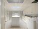 Large laundry room with granite counters, white cabinets, island, and ample storage at , Roswell, GA 30075