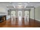 Elegant living room with hardwood floors, a fireplace, arched doorways, and built-in bookshelves at , Roswell, GA 30075