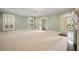 Inviting living room with light-colored walls, arch doorway, and natural light at , Roswell, GA 30075