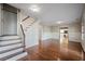 Bright living room boasts hardwood floors, wainscoting detail, and staircase leading to the upper level at , Roswell, GA 30075