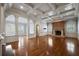 Open living room with a brick fireplace, hardwood floors, and custom coffered ceiling at , Roswell, GA 30075
