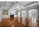 Elegant living room with coffered ceilings, arched doorways, built-ins, and hardwood floors at , Roswell, GA 30075