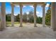 Covered patio featuring stone tile flooring and large columns offering peaceful views of the grounds at , Roswell, GA 30075