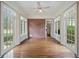 Sun room with brick accent wall and multiple doors leading outside at , Roswell, GA 30075