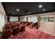 Home theater with projector, screen, and comfortable seating, next to a large mirrored room at , Roswell, GA 30075