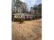 Charming brick home with a cozy front yard and mature trees, offering a serene suburban setting at 4300 Shady Lane Way, Forest Park, GA 30297