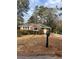 Quaint single-story brick home featuring a mailbox and a well-maintained lawn at 4300 Shady Lane Way, Forest Park, GA 30297