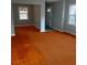Inviting living room features hardwood floors and ample natural light from large windows at 4300 Shady Lane Way, Forest Park, GA 30297