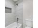 Tiled shower-tub combination with built-in niche and shower head at 5115 N Pratt St, Covington, GA 30014