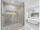Bathroom with walk-in shower, freestanding tub, and natural light from the window at 5115 N Pratt St, Covington, GA 30014