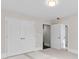 Bedroom featuring neutral walls and carpet, a flush mount light, and multiple doorways at 5115 N Pratt St, Covington, GA 30014