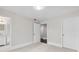 Bedroom featuring neutral walls and carpet, a flush light, and access to a bathroom and hallway at 5115 N Pratt St, Covington, GA 30014