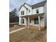 Charming two-story home featuring a covered porch, white siding, and a well-manicured front yard at 5115 N Pratt St, Covington, GA 30014