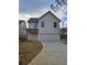 Charming two-story home featuring a large garage, white siding, and a well-manicured front yard at 5115 N Pratt St, Covington, GA 30014