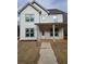 Charming two-story home featuring a covered porch, white siding, and a well-manicured front yard at 5115 N Pratt St, Covington, GA 30014