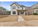 Charming two-story home featuring a covered porch, board and batten siding, and a well-manicured front yard at 5115 N Pratt St, Covington, GA 30014